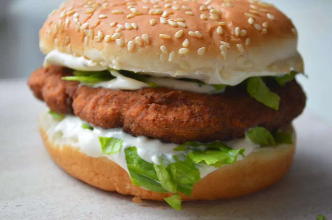 Soczysty burger z panierowanym, **red chikker** w bułce z sezamem, sałatą i majonezem.